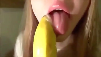 Cute Girl Sucking a Banana with Condom